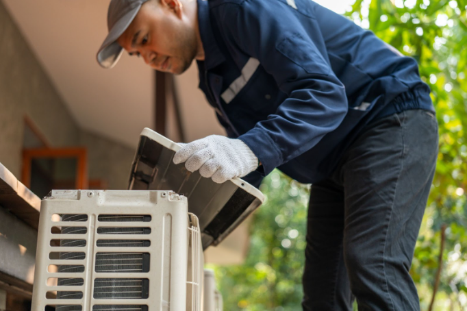 Air conditioner service outdoor checking fix repair. HVAC Manassas, VA technician. He opened the front cover and took out the filters and washed it.